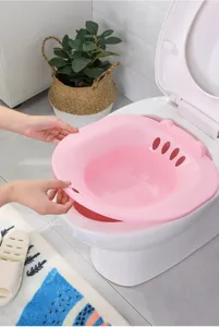 Pink plastic sitz bath basin for postpartum care and hemorrhoids relief, toilet accessory.