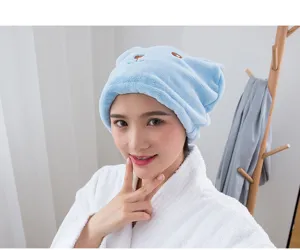 Detail shot of the cute bear ear coral fleece dry hair cap showing soft texture and cozy wear.