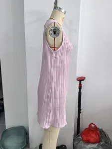 Light pink sleeveless pleated dress side detail view, elegant minimalist short dress design.