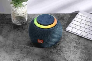 Compact spherical Bluetooth speaker detail showing control buttons and colorful ambient light ring.