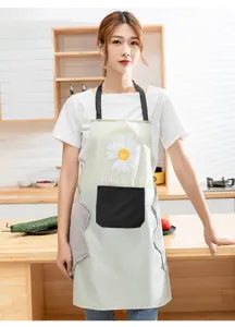 Kitchen apron detail showcasing cute daisy graphic, front pocket, and side hand-wiping towels.
