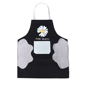 Waterproof kitchen apron with wipeable hands pockets and cute daisy print for home cooking tasks.