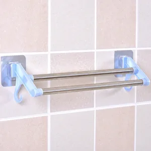 Close up view of stainless steel double towel rack installed on bathroom wall with handy hooks.