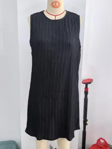 Detail view of a chic black sleeveless pleated dress, elegant round neck design for summer.