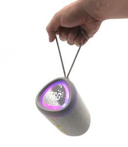 Portable TWS Bluetooth speaker featuring colorful LED lighting effects and a convenient carrying strap.