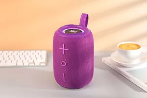 Haut-parleur Bluetooth portable violet gros plan, texture tissu, anneau lumineux LED.