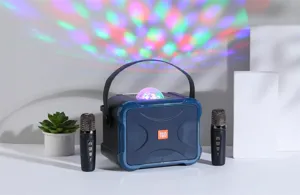 Portable Bluetooth karaoke speaker with dual wireless microphones and colorful disco ball lights.