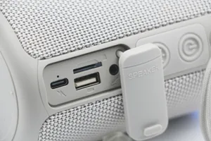 Detail view of portable wireless Bluetooth speaker charging ports, TF card slot and buttons.