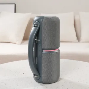 Close-up of the portable bluetooth speaker with fabric mesh, handle, and integrated control buttons.