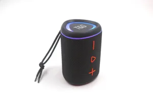 Portable wireless bluetooth speaker close-up view showing black fabric mesh and LED light.