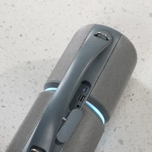 Portable wireless Bluetooth speaker with handle, gray mesh fabric and cool blue lights.
