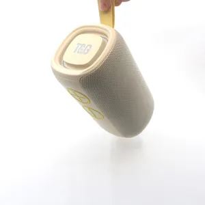 Portable wireless Bluetooth speaker with mesh fabric, outdoor heavy bass sound in beige color.
