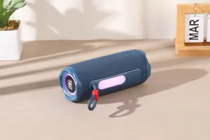 Close-up detail of portable Bluetooth speaker with RGB light strip and carrying cord.