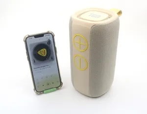 Portable wireless bluetooth speaker detail showing fabric mesh and volume buttons.