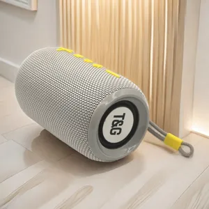 Outdoor portable wireless bluetooth speaker detail, cylindrical fabric mesh design with strap.