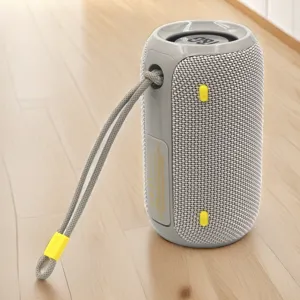 Portable wireless Bluetooth speaker with fabric mesh design and convenient carrying strap for outdoor.