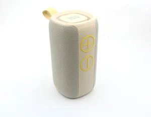 Detail view of portable wireless Bluetooth speaker with woven mesh and yellow control buttons.