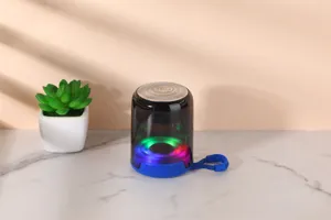 Detailed close-up of portable Bluetooth speaker with colorful LED lights and clear shell.
