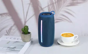 Portable waterproof bluetooth speaker with colorful LED light and strap for outdoor use.