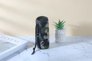 Detail view of the portable outdoor bluetooth speaker with camo pattern and lanyard.