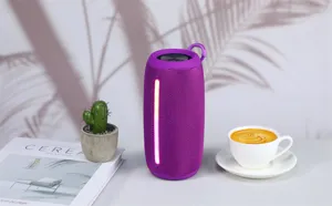 Portable purple bluetooth speaker detail view featuring ambient led light bar and hanging loop.