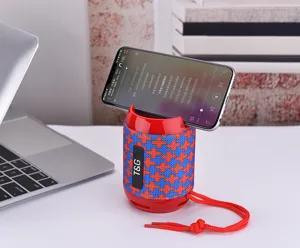 Portable Bluetooth speaker detail shot with red blue fabric finish and phone holder stand