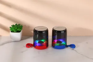 Detail view of portable wireless bluetooth speakers with colorful LED lights, red and blue bases.