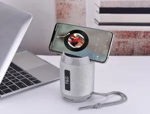Portable Bluetooth speaker with phone holder stand, grey wireless stereo subwoofer for desktop.