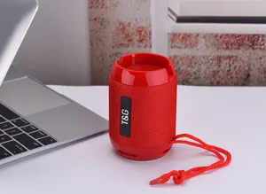 Close-up view of portable red wireless bluetooth speaker with fabric mesh and hanging lanyard