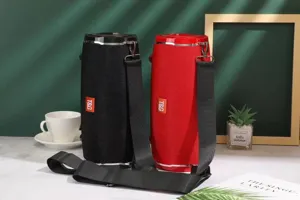 Portable outdoor waterproof Bluetooth speaker with strap and cylindrical fabric design.