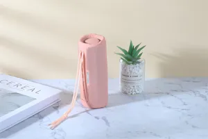Pink portable waterproof bluetooth speaker with hanging strap for outdoor music and heavy bass.
