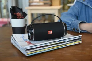 Tragbarer kabelloser Bluetooth Lautsprecher mit Stoffgeflecht und Griff für den Schreibtisch.