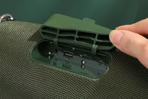 Detailed view of portable outdoor bluetooth speaker port panel with waterproof rubber cover.