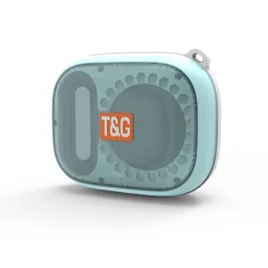 Close-up of portable macaron blue bluetooth speaker, mesh grille detail and hanging loop.