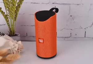 Portable wireless Bluetooth speaker with vibrant orange fabric and deep bass for outdoor use.