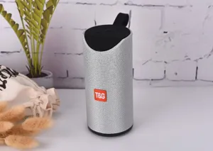 Portable wireless bluetooth speaker with fabric mesh, deep bass, waterproof design.