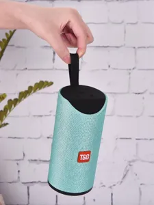 Portable wireless bluetooth speaker detail view showing mint green mesh fabric and handle.