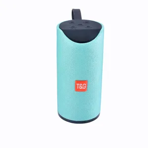 Portable wireless Bluetooth speaker with teal mesh fabric, compact cylindrical design for outdoor.