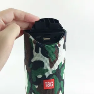 Portable waterproof bluetooth speaker detail view showing interface and camo fabric design.