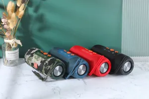 Enceinte bluetooth cylindrique portable avec des basses riches, design en tissu coloré et sans fil.