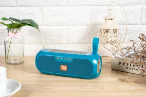 Portable blue solar bluetooth speaker detail view with solar panel and physical control buttons.