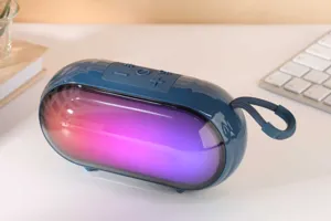 Portable wireless Bluetooth speaker with vibrant RGB lighting, deep bass, and convenient carry strap.
