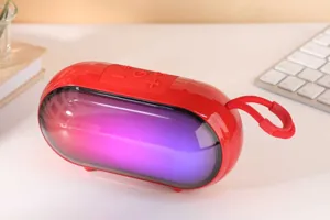 Portable wireless Bluetooth speaker with vibrant RGB lighting, compact design, and handy strap.