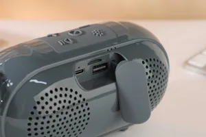 Portable wireless Bluetooth speaker detail view showing buttons and charging ports clearly.