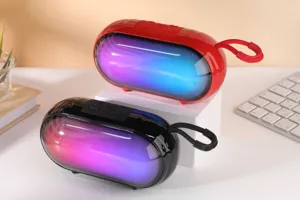 Portable wireless Bluetooth speaker showcasing vibrant RGB lighting and top control buttons.