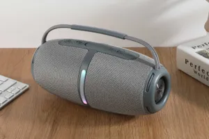 Portable wireless Bluetooth speaker with heavy bass, RGB lights, and convenient handle for outdoor use.