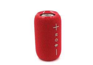 Red portable wireless bluetooth speaker detail view, compact fabric mesh design item.