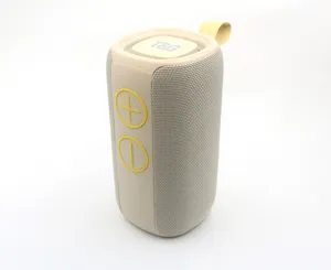 Portable wireless Bluetooth speaker with fabric mesh, deep bass, and convenient hanging strap.