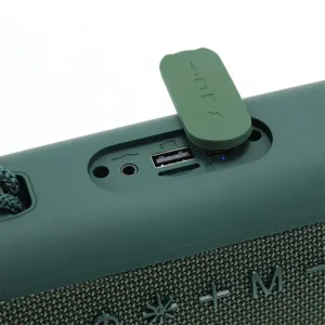 Nahaufnahme der gummierten Anschlussabdeckung und des Stoffgeflechts am Bluetooth-Lautsprecher.