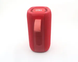 Close-up detail of the red portable bluetooth speaker with durable mesh fabric and strap.